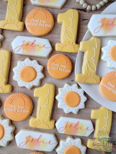 some decorated cookies are on a plate and next to other items that have been placed on the table