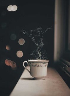 a coffee cup with steam rising out of it