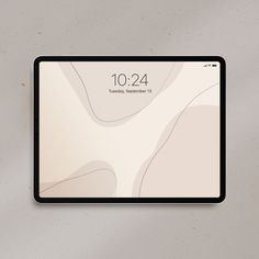 a tablet with the time displayed on it's screen and an image of a desert landscape