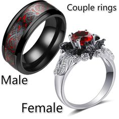 two wedding rings with red and black diamonds on each side, one has an oval shaped center