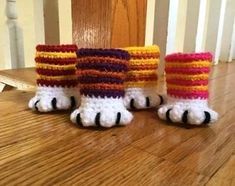 three crocheted feet with colorful socks on them