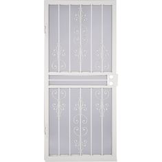 a white iron door with decorative designs on the glass and metal bars that are attached to it