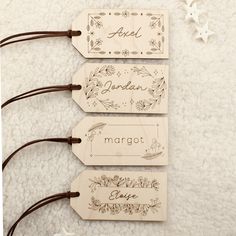 three wooden tags with the words margot, angel and snowflakes on them