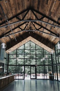 the inside of a large building with lots of windows and wood ceilinging on it