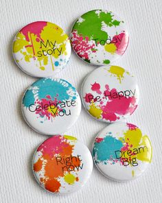 six buttons with the words celebrate you and paint splattered on them in different colors