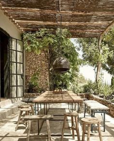 an outdoor dining area with wooden tables and chairs