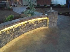 a stone wall with lights around it