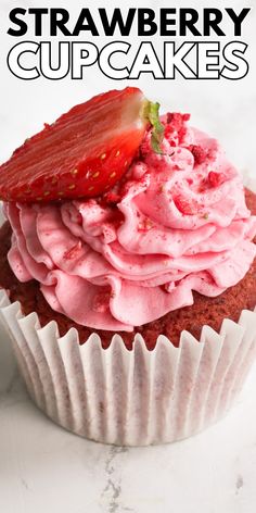 strawberry cupcakes with pink frosting and strawberries on top