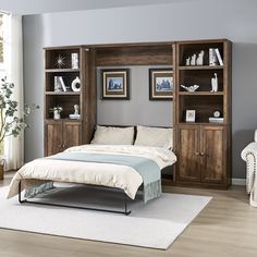 a bed sitting next to a book shelf in a bedroom