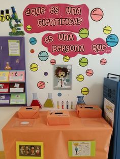 an orange table topped with lots of bottles and containers next to a wall covered in stickers