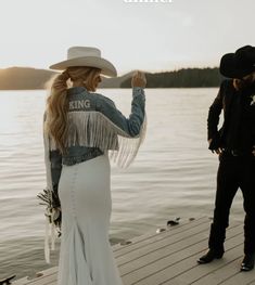 a man standing next to a woman wearing a cowboy hat