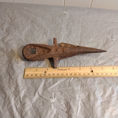 an old metal object with a ruler on it