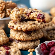 cranberry oatmeal breakfast cookies stacked on top of each other with fresh cherries in the background