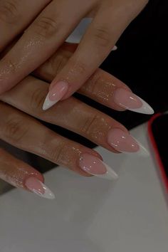 a woman's hands with white and pink manies