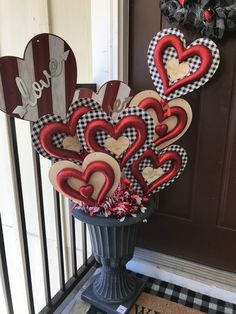 a vase filled with hearts sitting on top of a door