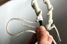 a hand holding a piece of white rope