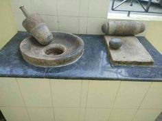 two stone sinks sitting next to each other on top of a blue counter in a bathroom