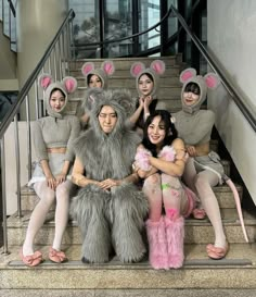 several women in bunny costumes sitting on the steps