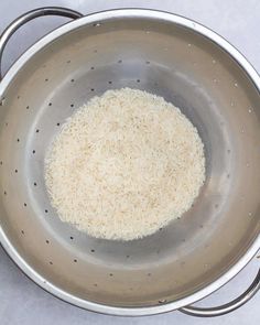 rice in a large metal bowl on a table