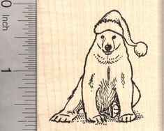 a rubber stamp with a bear wearing a santa hat