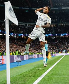 a soccer player is jumping in the air to celebrate his goal with an excited look on his face