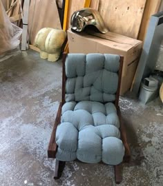 a chair that is sitting on the floor in a room with boxes and other items