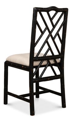 a black bamboo chair with a beige seat pad on the back and an upholstered cushion