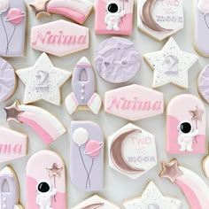 decorated cookies with pink and white icing are arranged in the shape of baby's name