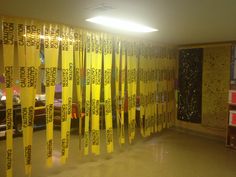 a room that has yellow tape on the wall and some bookshelves behind it