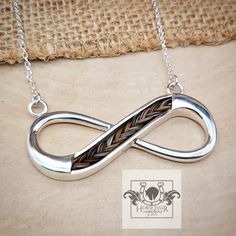 a silver necklace with an infinite symbol on it