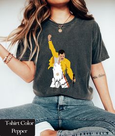 Freddie Mercury Shirt | Queen Band T-Shirt | Rock Band | 80S Nostalgia Vintage Queen Tshirt | Queen Band Shirt  Comfort Colors introduces its garment-dyed t-shirt; a fully customizable tee made 100% with ring-spun cotton. The soft-washed, garment-dyed fabric brings extra coziness to your wardrobe while the relaxed fit makes it an excellent daily choice. The double-needle stitching throughout the tee makes it highly durable while the lack of side-seams helps the shirt retain its tubular shape. .: 100% ring-spun cotton .: Medium fabric (6.1 oz/yd² (206.8 g/m .: Relaxed fit .: Sewn-in twill label Shirt Rock Bands, Queen Band Shirt, 80s Nostalgia, Queen Tshirt, Queen Band, Band Shirt, Band Shirts, Freddie Mercury, Dyed Fabric