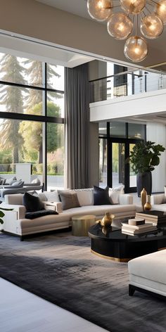 a living room filled with lots of furniture and a large window covered in glass doors