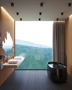 a bathroom with a large window overlooking the trees and mountains is shown in this image