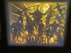 a shadow box with cutouts of superheros and the word'marvel'in it