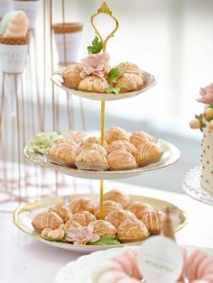 three tiered trays filled with pastries on top of a table