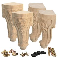 three carved wooden stools with screws and nails in front of them on a white background