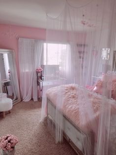 a bedroom with pink walls and white curtains