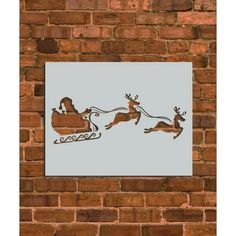 a painting on the side of a brick wall depicting santa's sleigh