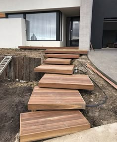 the steps are made out of wood in front of a house that is under construction