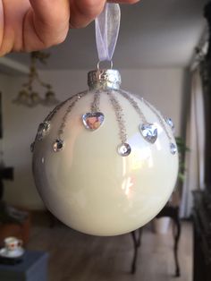 a white ornament with hearts hanging from it