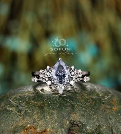 a close up of a ring on top of a rock