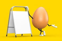 an egg with arms and legs leaning against a sign on a yellow background next to it