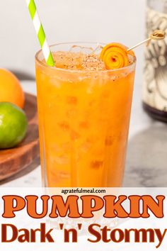 a pumpkin drink in a tall glass with a green and white straw garnish