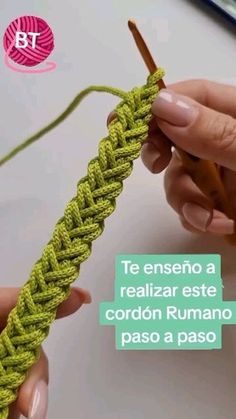 someone is crocheting the end of a piece of yarn with two hands and one hand