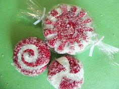 three lollipops sitting on top of a green table