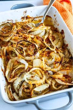 a casserole dish filled with onions and cheese