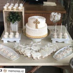 a table topped with a white cake and lots of cupcakes