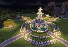 a large fountain in the middle of a park at night