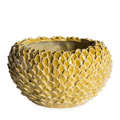 a gold bowl with large petals on it