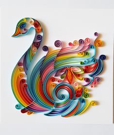 a colorful paper cut swan with swirls on it